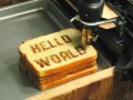 Toast with Hello World printed on it via a CNC Printer